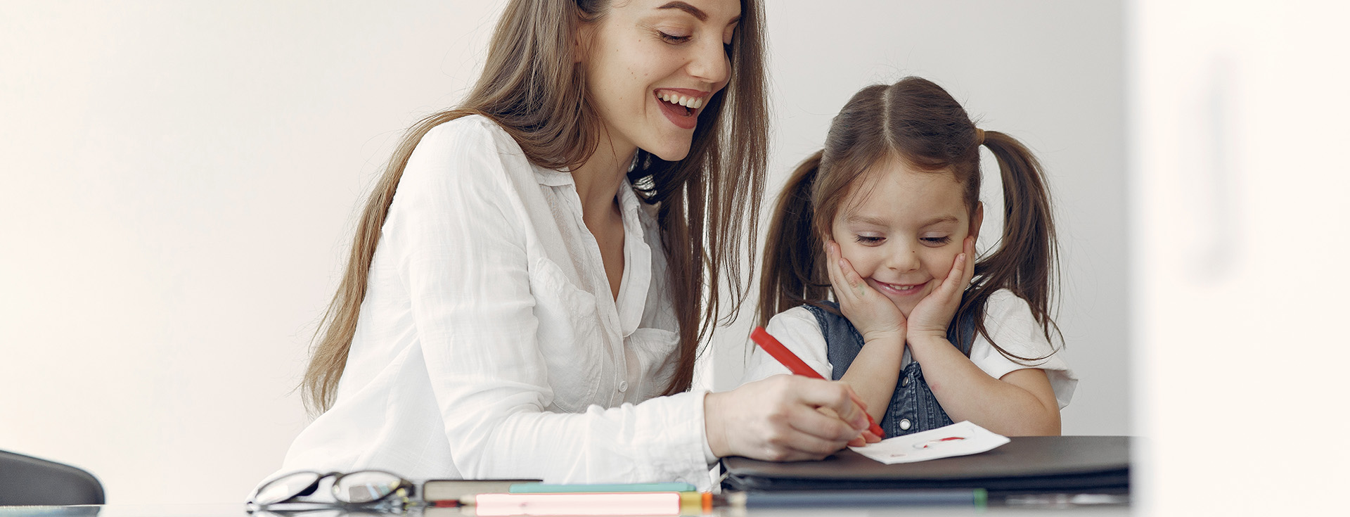 Tutor with litthe girl studying at home