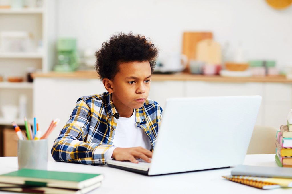 African Boy Using Laptop for Online Class